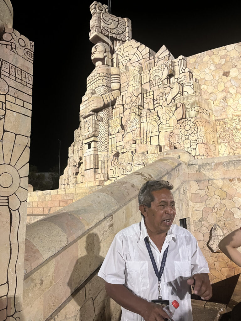 night shot in Mexico of a tour guide at a stone structure.