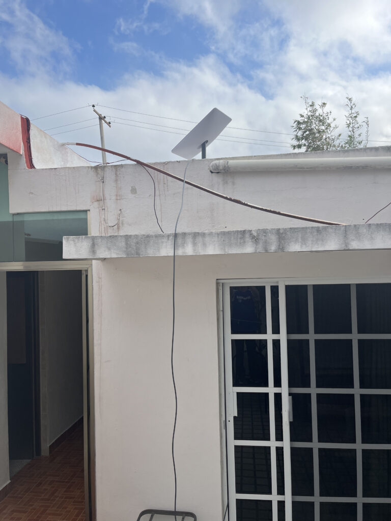 satellite dish on top of a white building